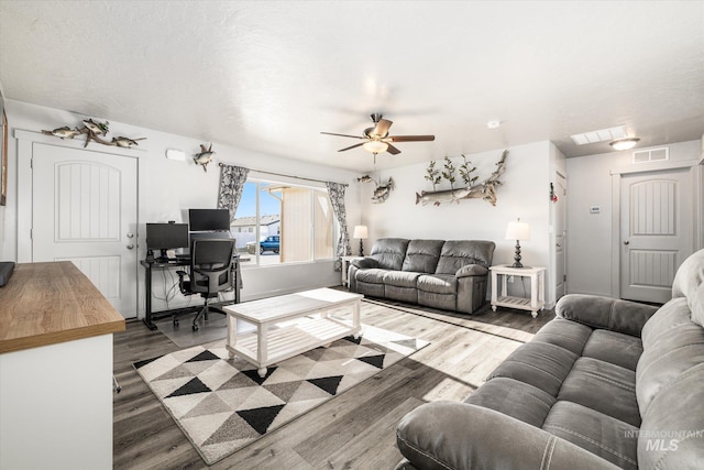 living room featuring wood-type flooring and ceiling fan