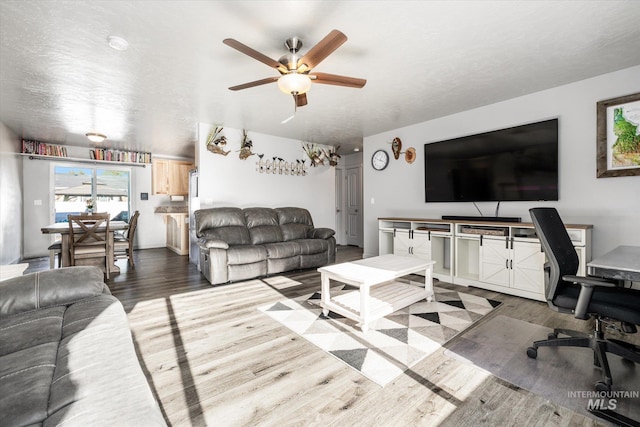 living room with light wood-type flooring and ceiling fan