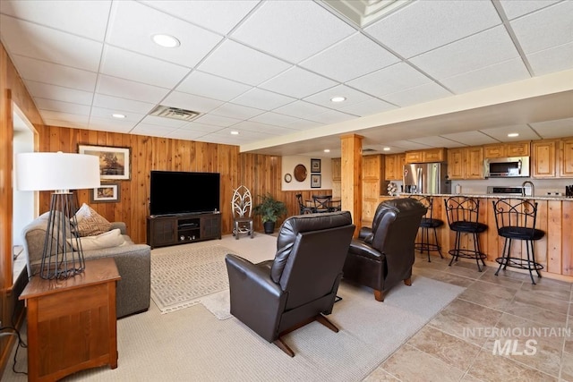 1640 S 5th W, Mountain Home, ID 83647 - living room featuring wooden walls, a paneled ceiling, and recessed lighting