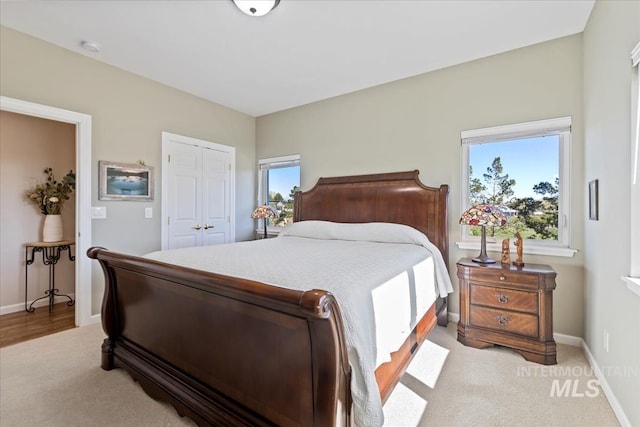 1640 S 5th W, Mountain Home, ID 83647 - bedroom with light colored carpet, a closet, and baseboards