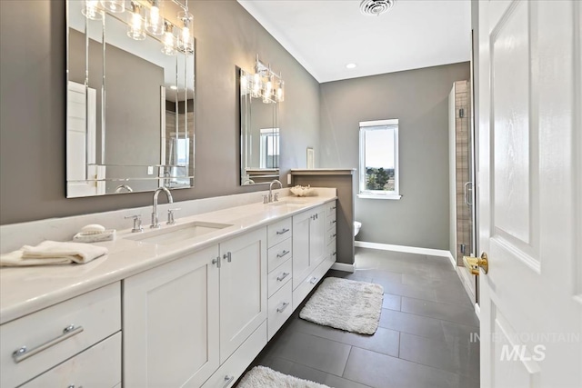 1640 S 5th W, Mountain Home, ID 83647 - bathroom featuring double vanity, tile patterned flooring, toilet, baseboards, and a shower stall