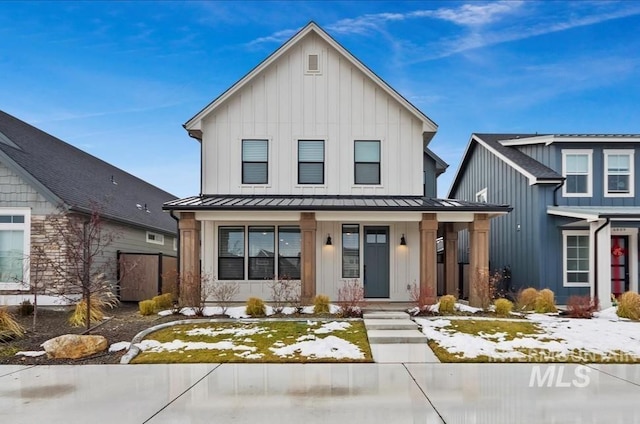 modern inspired farmhouse with metal roof, a porch, a standing seam roof, and board and batten siding