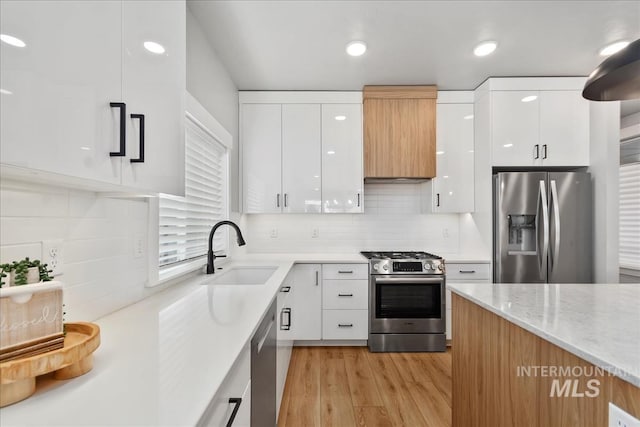 6811 W Los Flores Dr, Meridian, ID 83646 - kitchen featuring modern cabinets, appliances with stainless steel finishes, white cabinets, and a sink