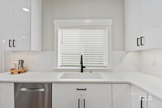 6811 W Los Flores Dr, Meridian, ID 83646 - kitchen with dishwasher, a sink, light countertops, white cabinetry, and backsplash