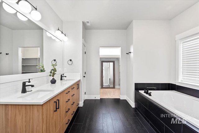 6811 W Los Flores Dr, Meridian, ID 83646 - full bathroom with a garden tub, wood finished floors, a sink, and visible vents