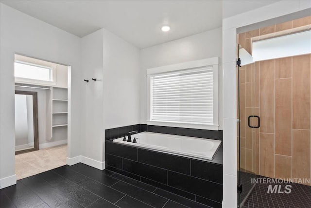6811 W Los Flores Dr, Meridian, ID 83646 - bathroom featuring a stall shower, wood finished floors, baseboards, and a bath