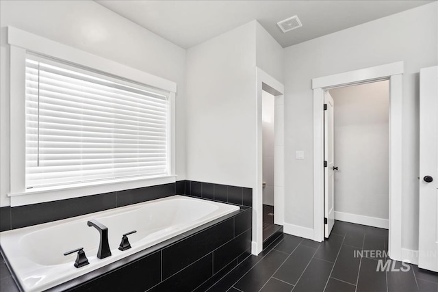 6811 W Los Flores Dr, Meridian, ID 83646 - full bathroom featuring tile patterned flooring, a garden tub, visible vents, and baseboards