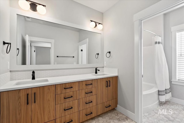 6811 W Los Flores Dr, Meridian, ID 83646 - bathroom featuring double vanity, baseboards, a sink, and tile patterned floors