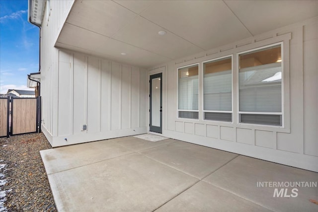 6811 W Los Flores Dr, Meridian, ID 83646 - doorway to property with a patio area, fence, and board and batten siding