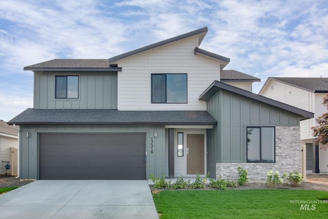 view of front of home with a front yard and a garage