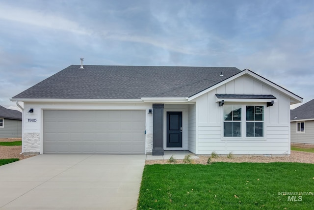 view of front facade with a shingled roof, concrete driveway, board and batten siding, a garage, and a front lawn