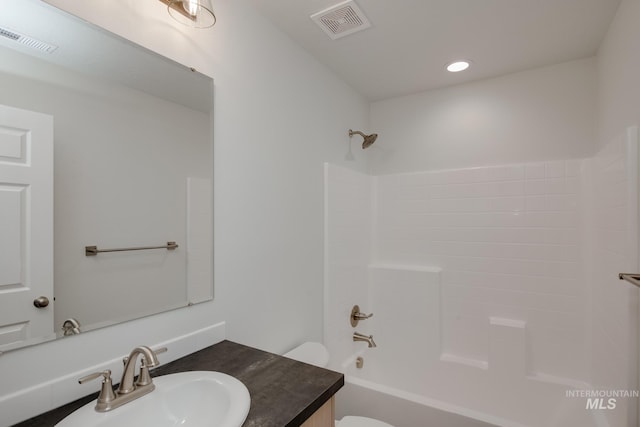 bathroom featuring toilet, shower / washtub combination, vanity, and visible vents