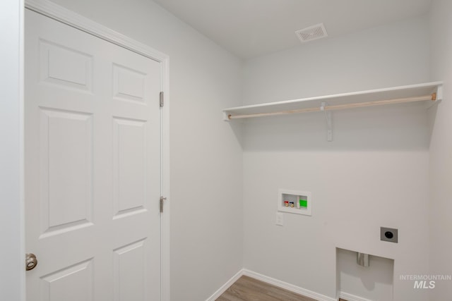 laundry room with hookup for an electric dryer, laundry area, washer hookup, visible vents, and baseboards