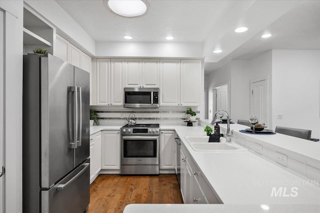 66 W Colchester Dr, Eagle, ID 83616 - kitchen featuring appliances with stainless steel finishes, a sink, recessed lighting, white cabinets, and light countertops