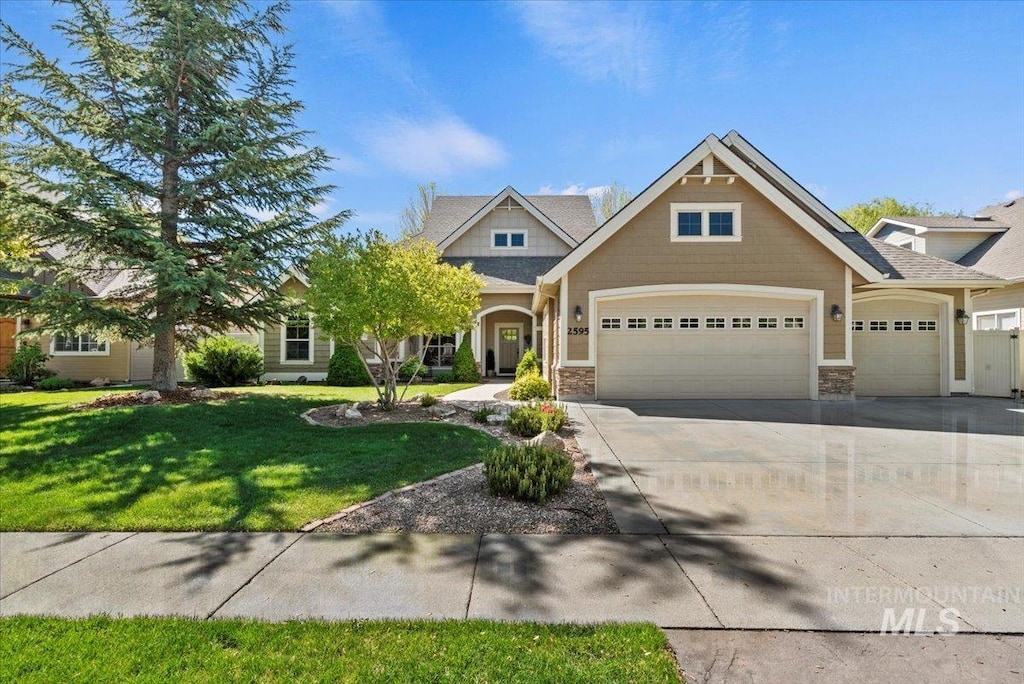 2595 Tybalt Dr, Meridian, ID 83642 - craftsman-style home featuring an attached garage, a front yard, concrete driveway, and stone siding