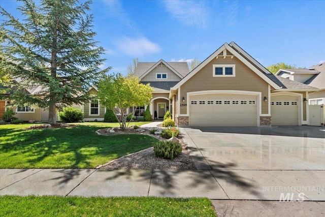 2595 Tybalt Dr, Meridian, ID 83642 - craftsman-style home featuring an attached garage, a front yard, concrete driveway, and stone siding