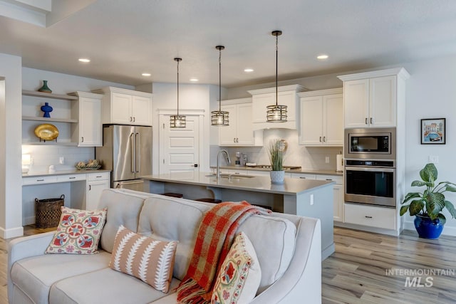 kitchen featuring appliances with stainless steel finishes, a sink, and white cabinets