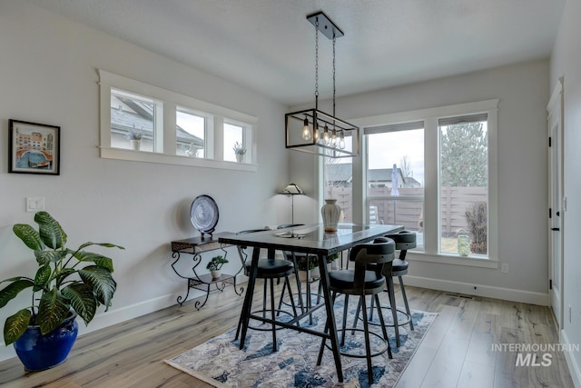 dining room featuring baseboards and wood finished floors