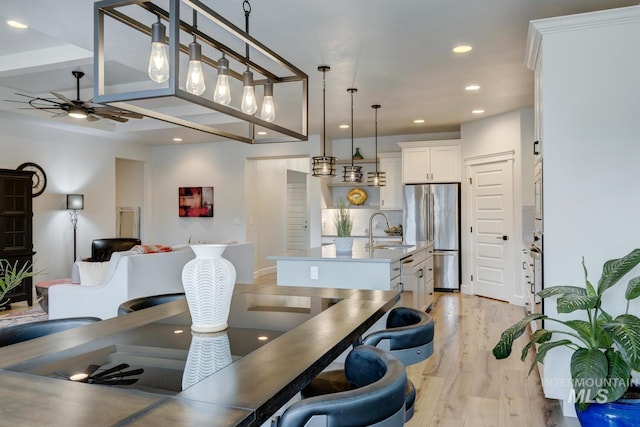 dining area with recessed lighting, ceiling fan, and light wood finished floors