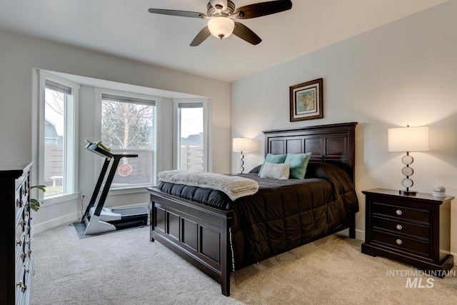 carpeted bedroom featuring ceiling fan and baseboards