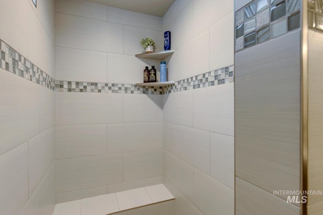 bathroom with a tile shower