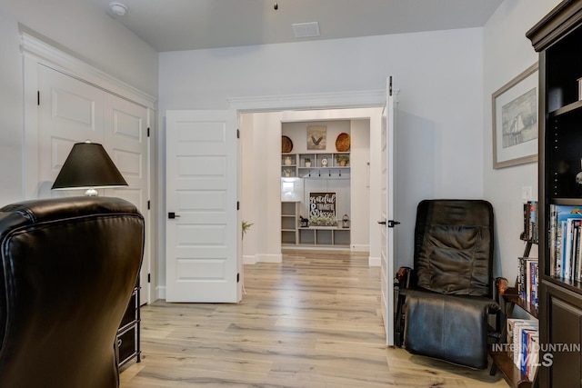 home office featuring light wood-type flooring and baseboards