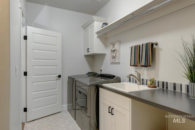 laundry room featuring a sink, cabinet space, and washer and dryer