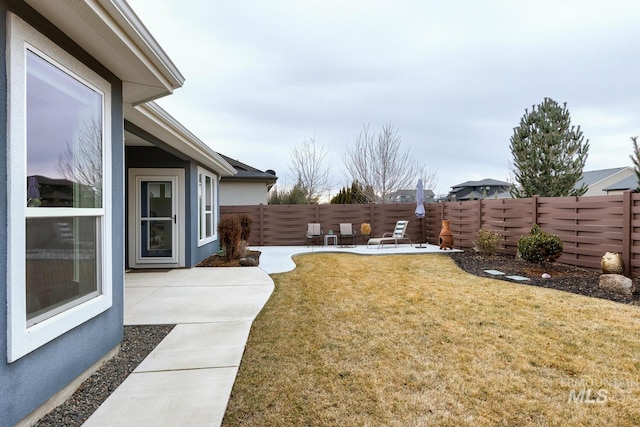 view of yard with a fenced backyard and a patio