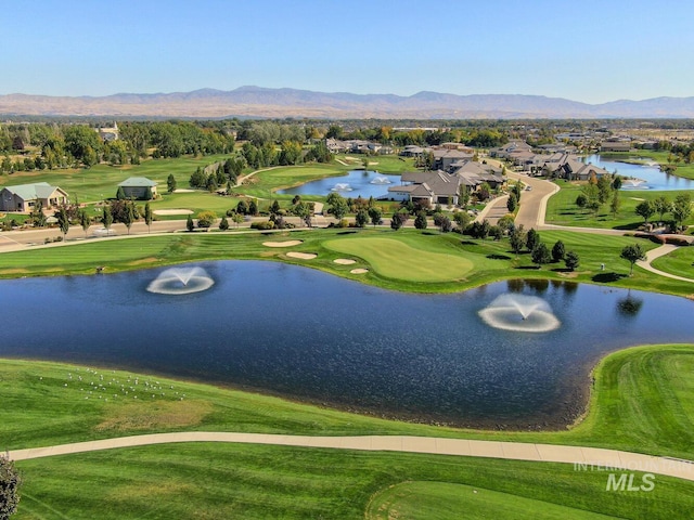 birds eye view of property featuring golf course view and a water and mountain view