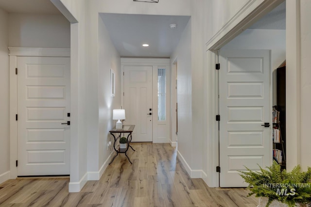 entryway featuring light wood-style flooring and baseboards