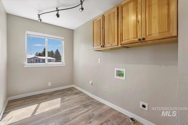 180 E Elmore, Richfield, ID 83349 - laundry room featuring washer hookup, cabinet space, hookup for an electric dryer, wood finished floors, and track lighting