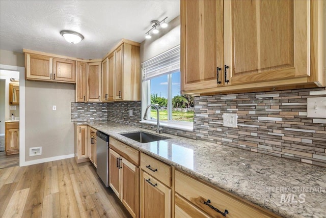 180 E Elmore, Richfield, ID 83349 - kitchen featuring light wood-style floors, stainless steel dishwasher, light stone counters, and tasteful backsplash