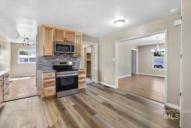 180 E Elmore, Richfield, ID 83349 - kitchen featuring stainless steel appliances, light brown cabinets, backsplash, light wood-style floors, and a chandelier