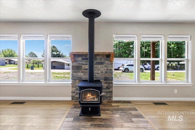 180 E Elmore, Richfield, ID 83349 - living area featuring a wood stove, wood finished floors, and plenty of natural light