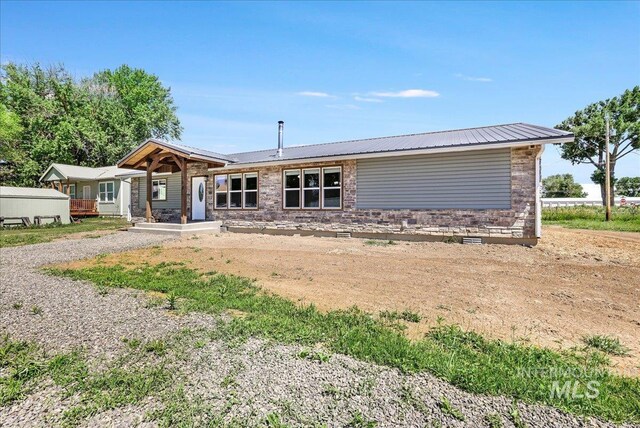 180 E Elmore, Richfield, ID 83349 - view of front facade with covered porch and a metal roof