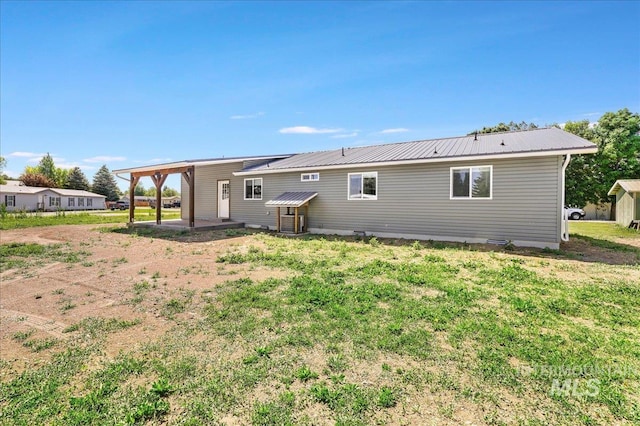 180 E Elmore, Richfield, ID 83349 - back of property with a metal roof, a yard, and a patio