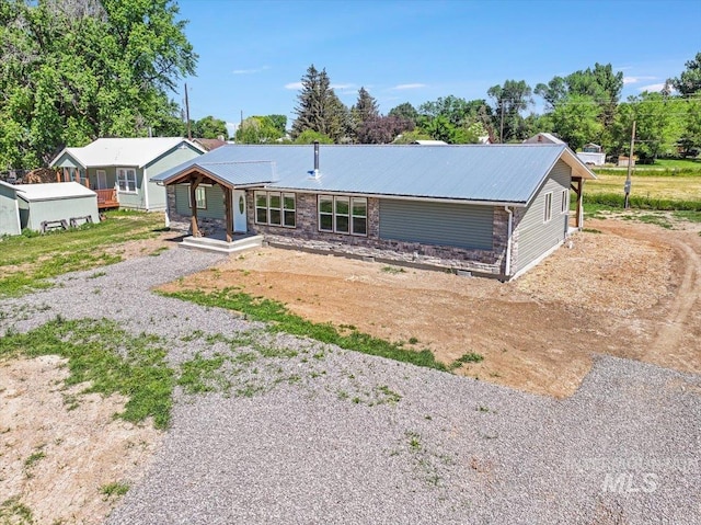 180 E Elmore, Richfield, ID 83349 - ranch-style home with driveway, a metal roof, and covered porch