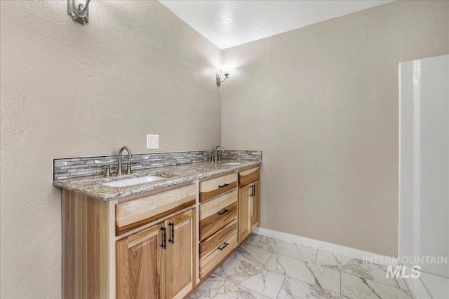 180 E Elmore, Richfield, ID 83349 - bathroom featuring marble look tiles and double vanity