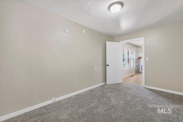 180 E Elmore, Richfield, ID 83349 - carpeted spare room with a textured wall and a textured ceiling
