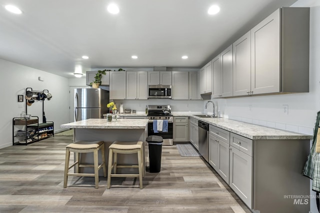 247 Washington St, Gooding, ID 83330 - kitchen featuring appliances with stainless steel finishes, a sink, gray cabinets, a kitchen island, and recessed lighting
