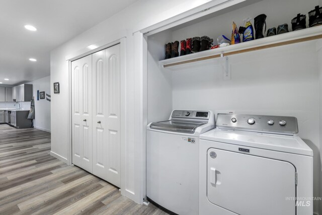 247 Washington St, Gooding, ID 83330 - washroom with washer and dryer, light wood-style flooring, and recessed lighting