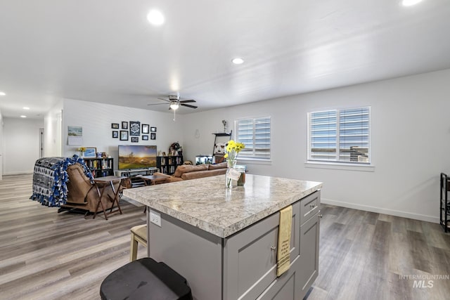 247 Washington St, Gooding, ID 83330 - kitchen with gray cabinets, light countertops, recessed lighting, a ceiling fan, and a center island