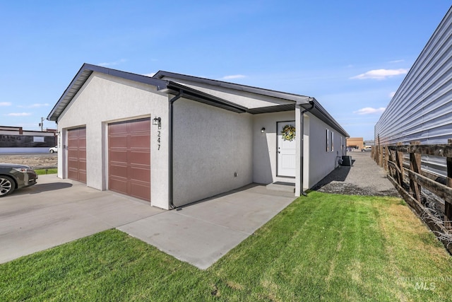247 Washington St, Gooding, ID 83330 - view of side of property with a garage and stucco siding