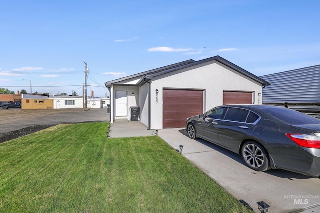 247 Washington St, Gooding, ID 83330 - ranch-style home featuring a front yard, stucco siding, concrete driveway, and an attached garage