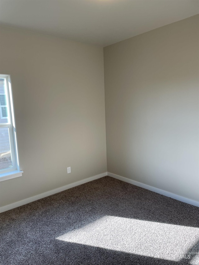 carpeted spare room with baseboards