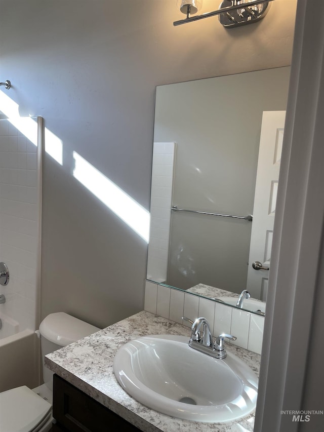 full bathroom with toilet and vanity