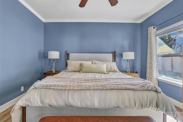 bedroom with baseboards, wood finished floors, a ceiling fan, and crown molding