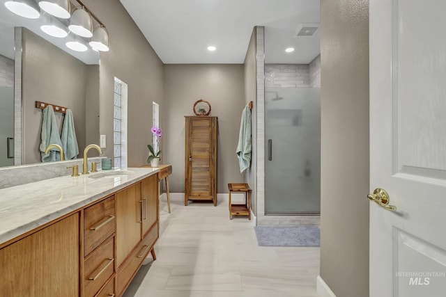 full bath with a shower stall, visible vents, baseboards, and vanity