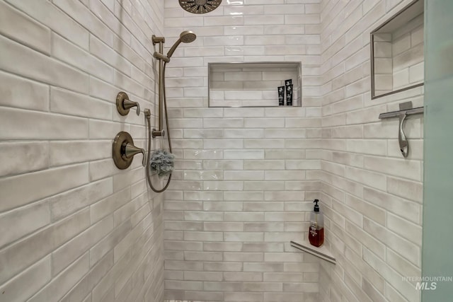 bathroom with a tile shower