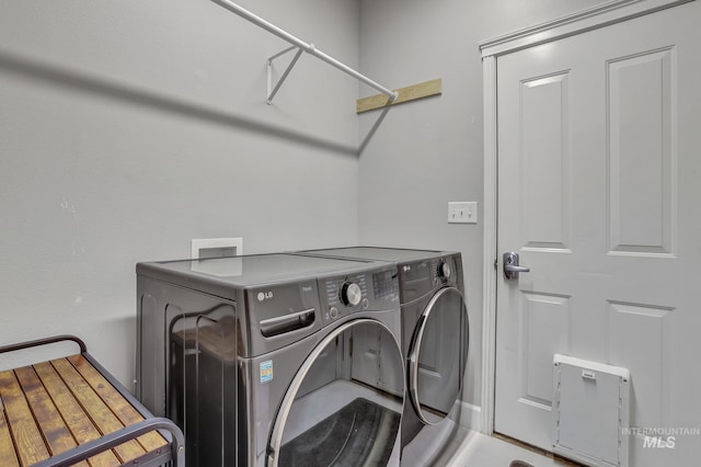 washroom featuring laundry area and separate washer and dryer